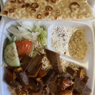 a plate of meat, rice, and vegetables