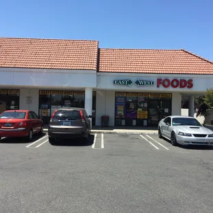 two cars parked in front of the store