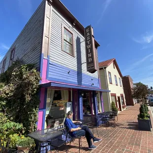 a person sitting outside of a restaurant
