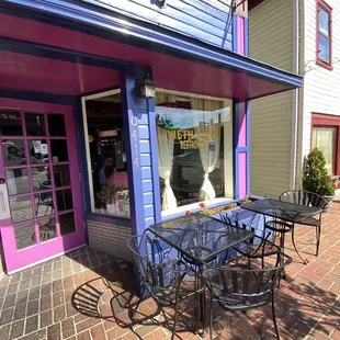 a table and chairs outside of a store