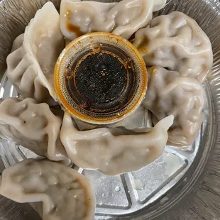 a plate of dumplings with sauce
