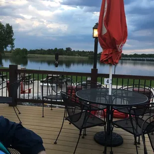 a man sitting on a deck overlooking a lake