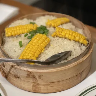 a bowl of rice and corn on the cob