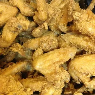 a pile of fried chicken on a tray