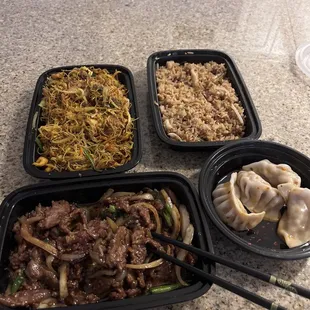 a variety of asian food in plastic containers