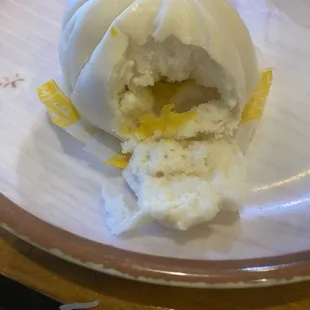a steamed bun with a bite taken out of it