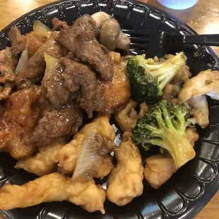 beef and broccoli on a paper plate
