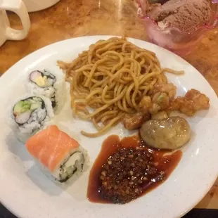 Lo mein, mushroom chicken, sushi and hot chili oil.