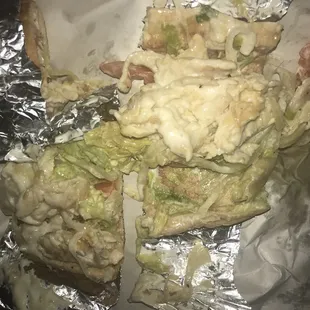 Cheesesteak cut into quarters, drenched in mayonnaise