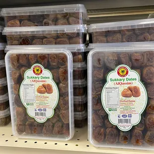 two containers of dried dates on a shelf