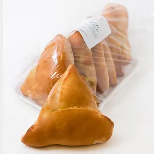 three pastries wrapped in plastic