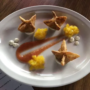 Banana filled wontons with guava purée, poached mango and cream cheese sauce.