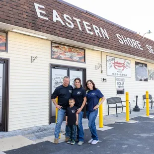 a family standing in front of a restaurant