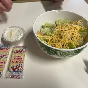 a bowl of salad with cheese