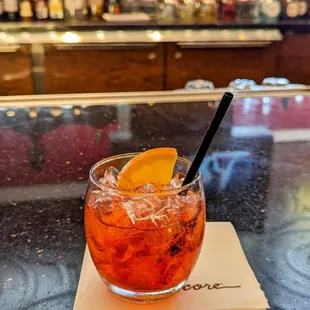 a glass of cocktail on a table