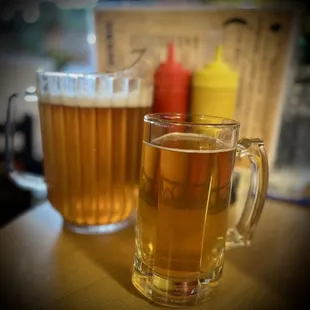 a glass of beer and a mug of beer