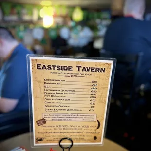 a table with a menu and condiments