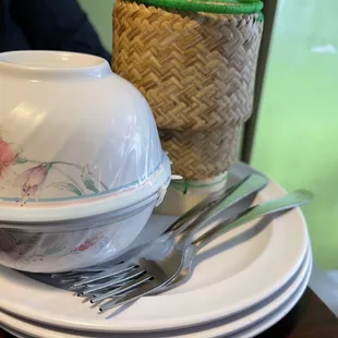 Plates, jasmine rice and sticky rice, forks