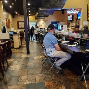 Picture of the restaurant and the sushi bar area they also have tables