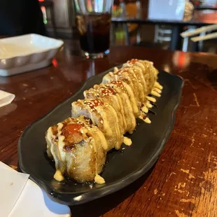 a sushi roll on a black plate