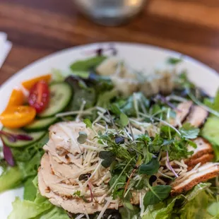 a plate of salad with chicken and vegetables