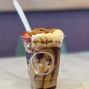 Delicious cup of açaí with peanut butter banana and strawberry