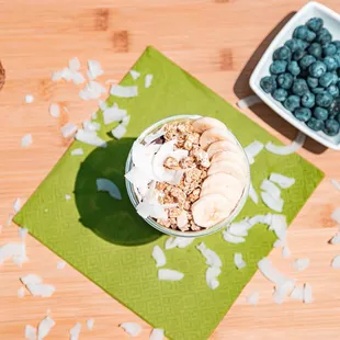 a bowl of oatmeal with bananas and blueberries