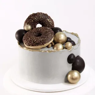 Sponge cake, decorated with chocolate balls and our special donuts