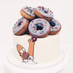 Custom cake, nutty sponge cake, print decor and our special donuts.