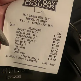 a hand holding a receipt