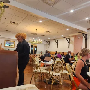 people sitting at tables in a restaurant