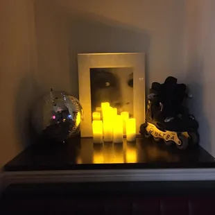 a picture of a lighted candle on a shelf