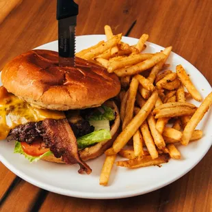 Fischer Farms beef burger with bacon, Cheddar cheese, special sauce, lettuce, tomato, onion, pickle, brioche bun and a choice of side