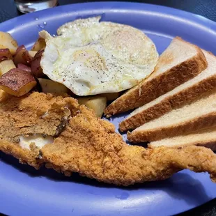My fried fish, red potatoes and over easy eggs.