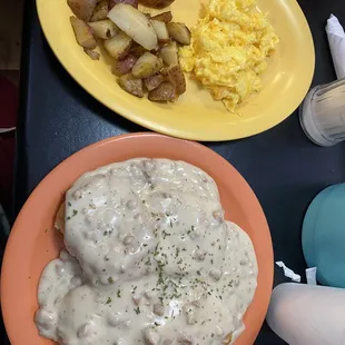 Biscuits &amp; gravy me with potatoes and scrambled eggs with cheese. Look at the loaded plate!