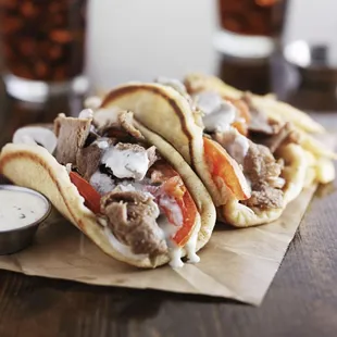two pita sandwiches with sauce