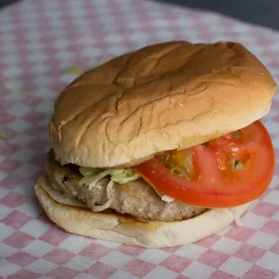 a hamburger with tomatoes and lettuce
