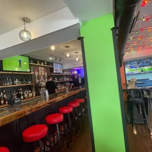 a bar with red stools