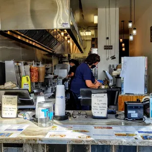 two people preparing food in a kitchen