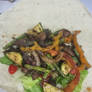 Veggie Wrap includes grilled bell peppers, onions, zucchini, squash and asparagus.