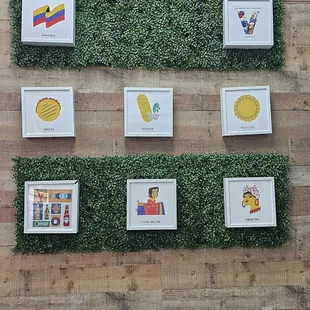 a variety of framed pictures on a wall