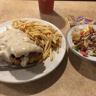 a plate of food and a bowl of fries