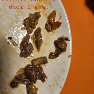 The tiny pieces of duck I fished out of from the &quot;Eat My Duck&quot; (wok section) dish I ordered.
