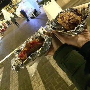 a person holding a hot dog