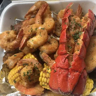 Lobster, fried shrimp, egg, sausage, potato and corn. Enough for 2 people, priced at $27