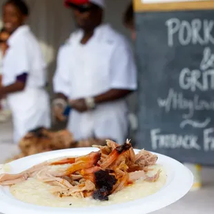 My plate of pork and grits with bbq sauce on top.