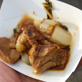 Smoked lamb shoulder over bok choy ragu with a lamb wine reduction sauce.