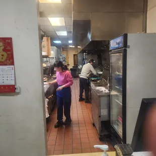 a woman standing in a restaurant kitchen