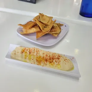 a plate of pita chips and dip