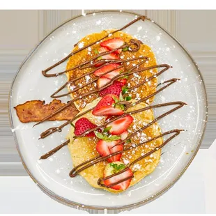 a crepe with strawberries and bacon